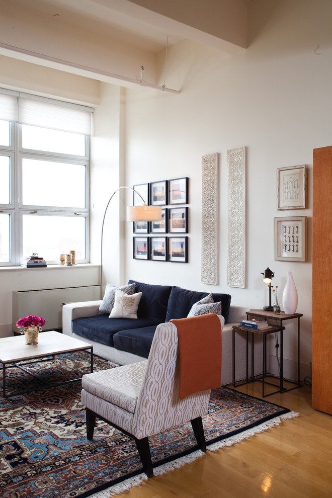 Design ideas for an eclectic living room in New York with white walls and medium hardwood flooring.