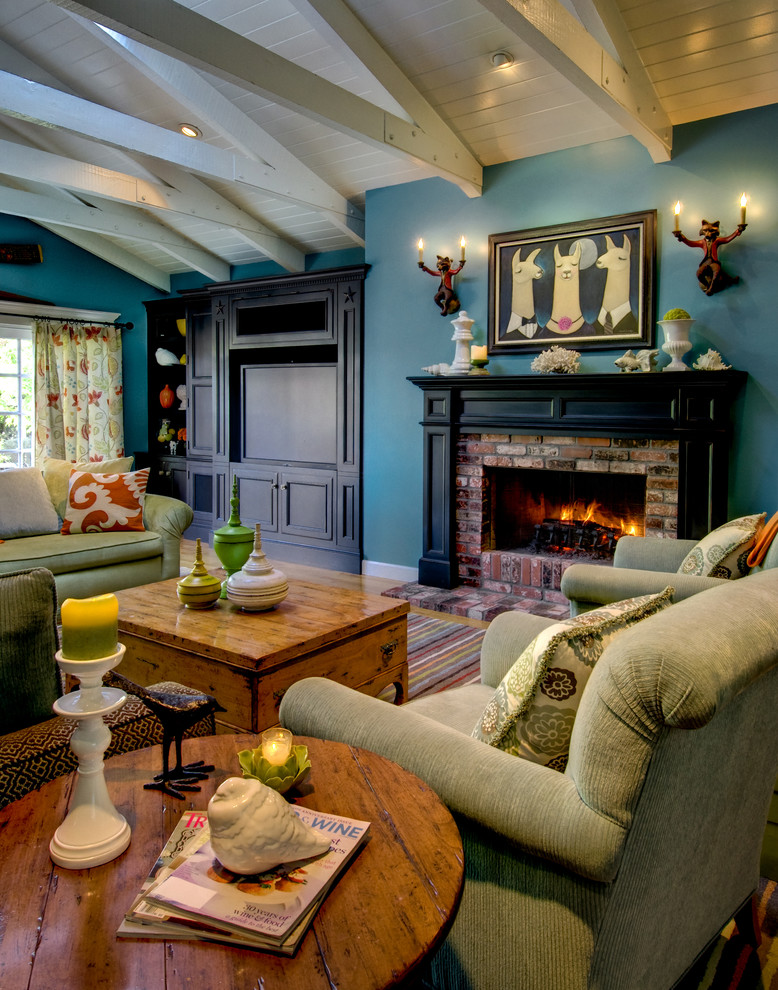 На фото: гостиная комната в стиле фьюжн с синими стенами, светлым паркетным полом, стандартным камином и фасадом камина из кирпича с