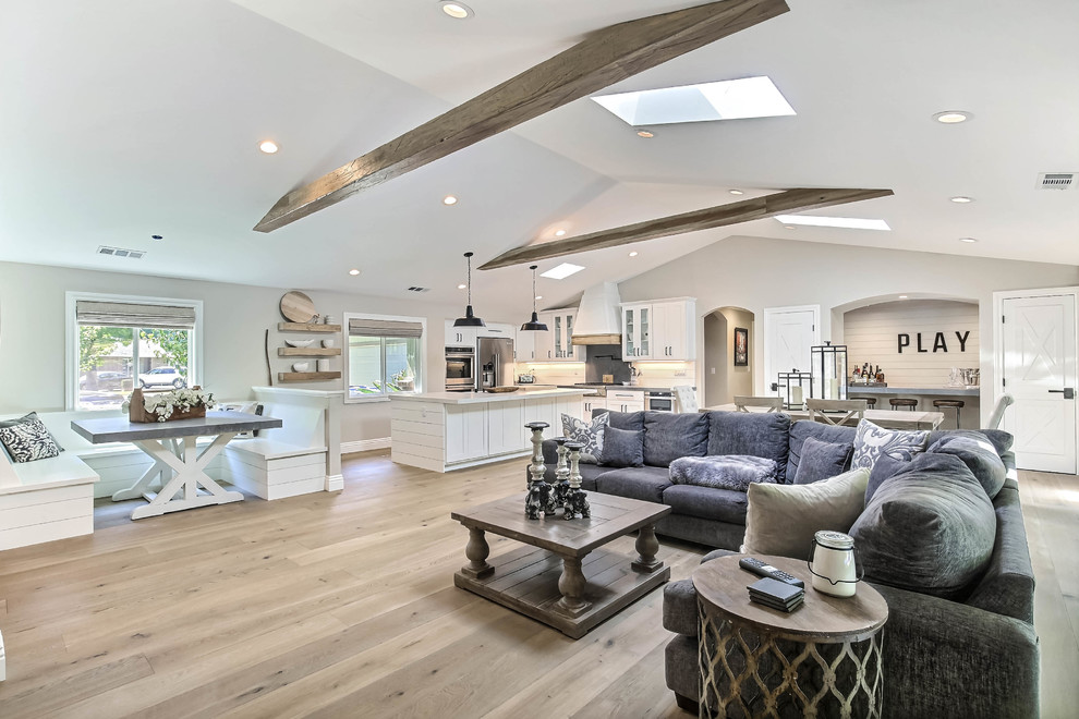 Large farmhouse formal open plan living room in San Francisco with grey walls, light hardwood flooring, no fireplace, no tv and beige floors.