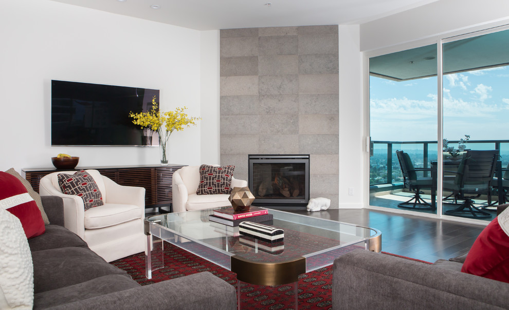 Photo of a large contemporary open plan living room in Los Angeles with white walls, dark hardwood flooring, a hanging fireplace, a stone fireplace surround, a wall mounted tv and grey floors.