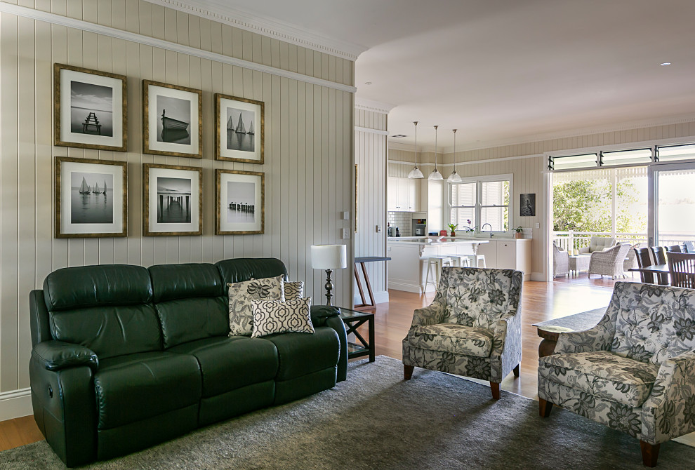 Inspiration for a medium sized bohemian formal open plan living room in Brisbane with white walls, light hardwood flooring, a freestanding tv and orange floors.
