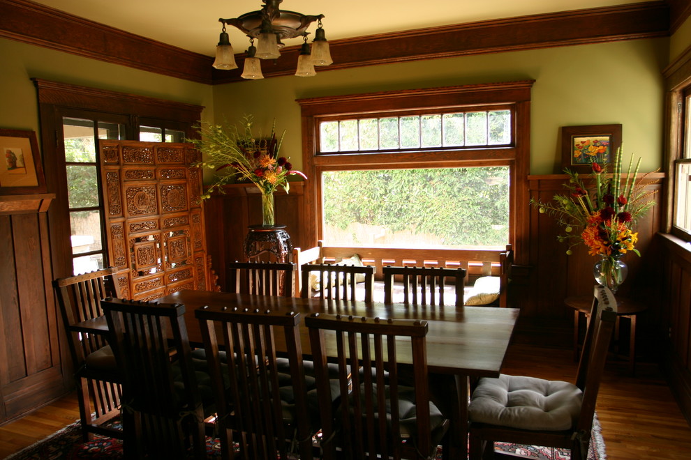 This is an example of a medium sized classic dining room in Hawaii with beige walls, light hardwood flooring, a standard fireplace and a brick fireplace surround.