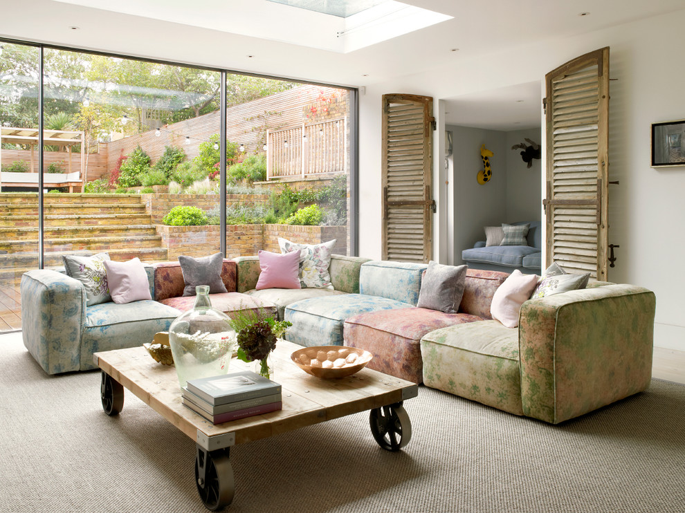 Living room - huge contemporary open concept carpeted and beige floor living room idea in London with white walls, no fireplace and a media wall