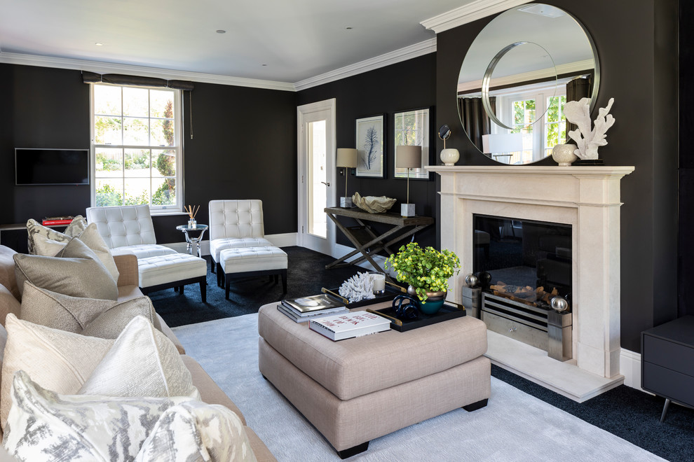 Inspiration for a classic formal living room in London with black walls, carpet and a standard fireplace.