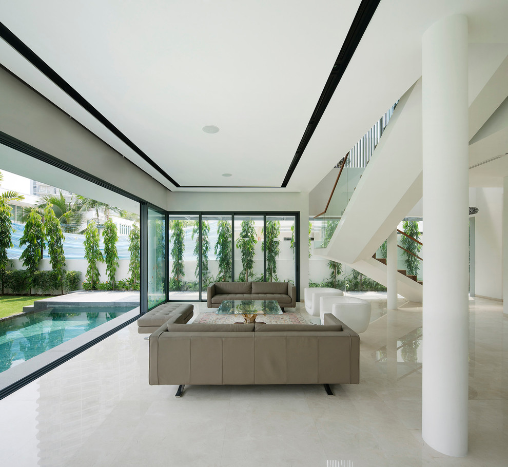 Contemporary open plan living room in Singapore with white walls.
