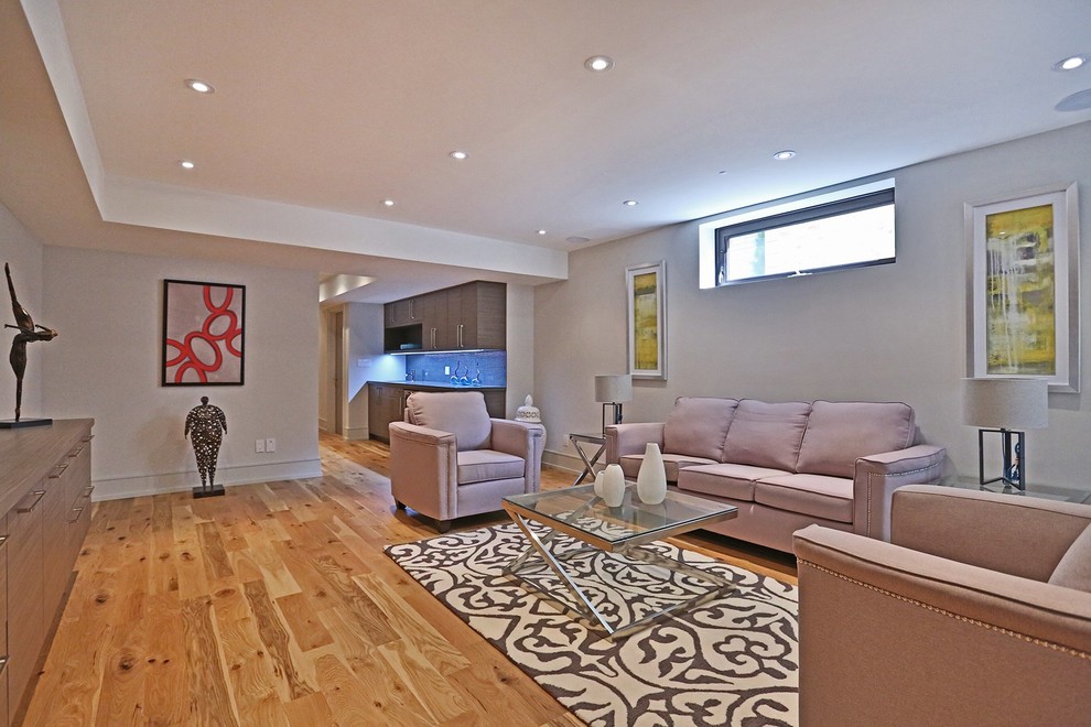 Medium sized modern formal open plan living room in Toronto with grey walls, medium hardwood flooring, no fireplace, no tv and brown floors.