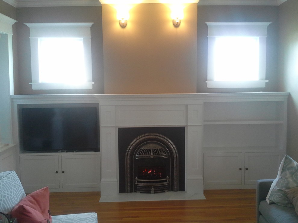 Small victorian formal enclosed living room in Minneapolis with marble flooring, a standard fireplace, a metal fireplace surround and a wall mounted tv.