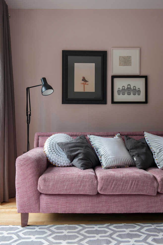 Eclectic light wood floor living room photo in Belfast with pink walls
