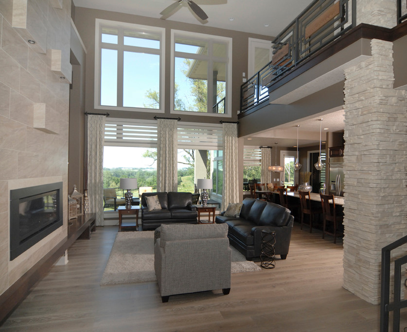 Photo of a large contemporary formal open plan living room in Other with brown walls, medium hardwood flooring, a standard fireplace, a stone fireplace surround, no tv and brown floors.