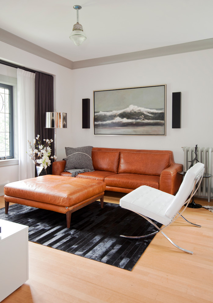 Свежая идея для дизайна: открытая гостиная комната в скандинавском стиле с белыми стенами, светлым паркетным полом и коричневым диваном - отличное фото интерьера