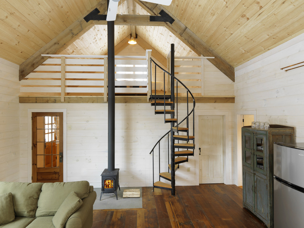 Living room - rustic open concept medium tone wood floor living room idea in Burlington with beige walls and a wood stove