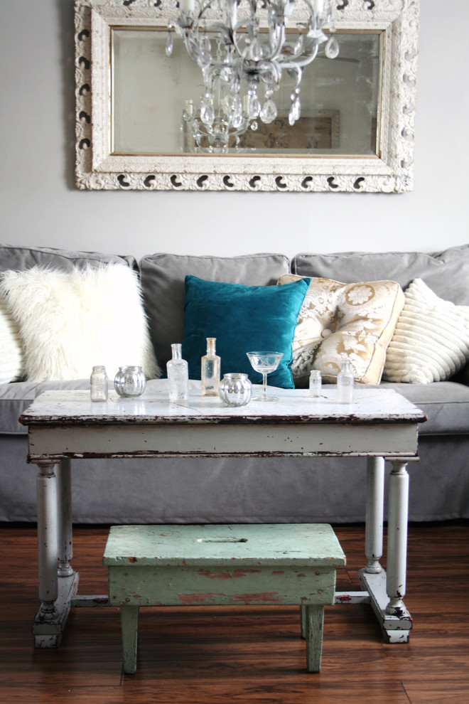 This is an example of an eclectic grey and teal living room in Other.