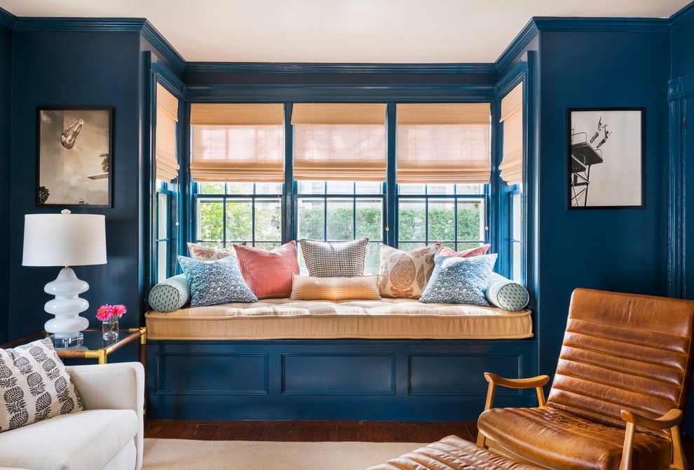 This is an example of a medium sized traditional living room in Orange County with blue walls, medium hardwood flooring and feature lighting.