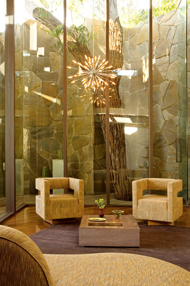 Inspiration for a mid-century modern medium tone wood floor living room remodel in Austin