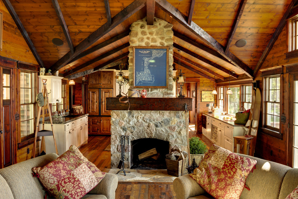 Mountain style living room photo in Minneapolis with a stone fireplace