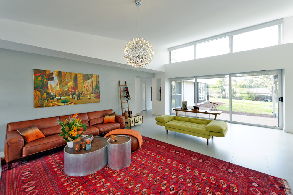 This is an example of a large contemporary open plan living room in Melbourne with grey walls.