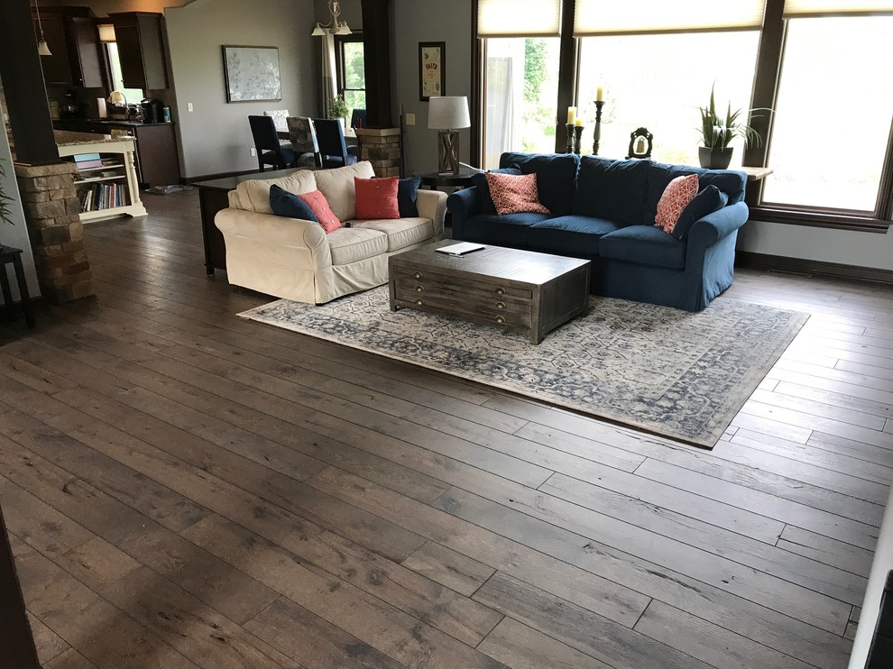 Photo of a medium sized traditional formal open plan living room in Cleveland with no tv, grey walls, dark hardwood flooring, a standard fireplace, a stone fireplace surround and brown floors.