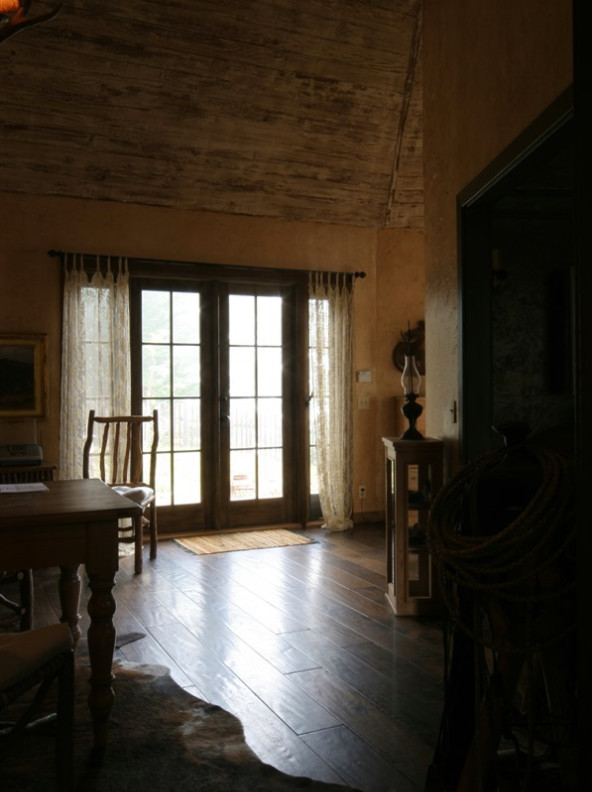 Foto de salón cerrado grande sin televisor con paredes beige, suelo de madera en tonos medios, todas las chimeneas, marco de chimenea de piedra y suelo marrón
