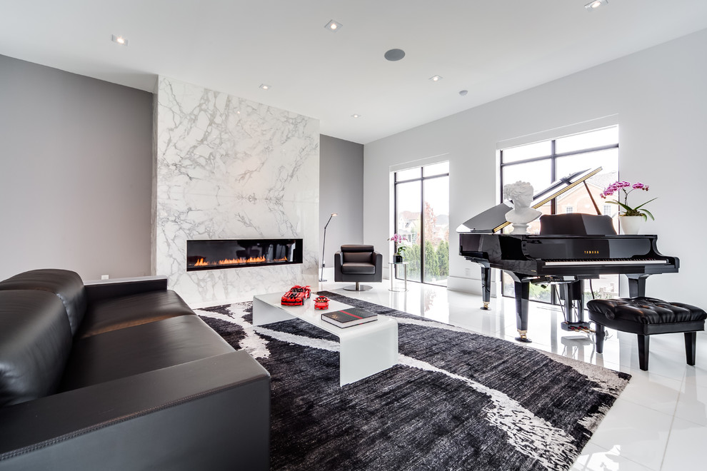 This is an example of a medium sized contemporary living room in Toronto with a music area, grey walls, a ribbon fireplace and a stone fireplace surround.