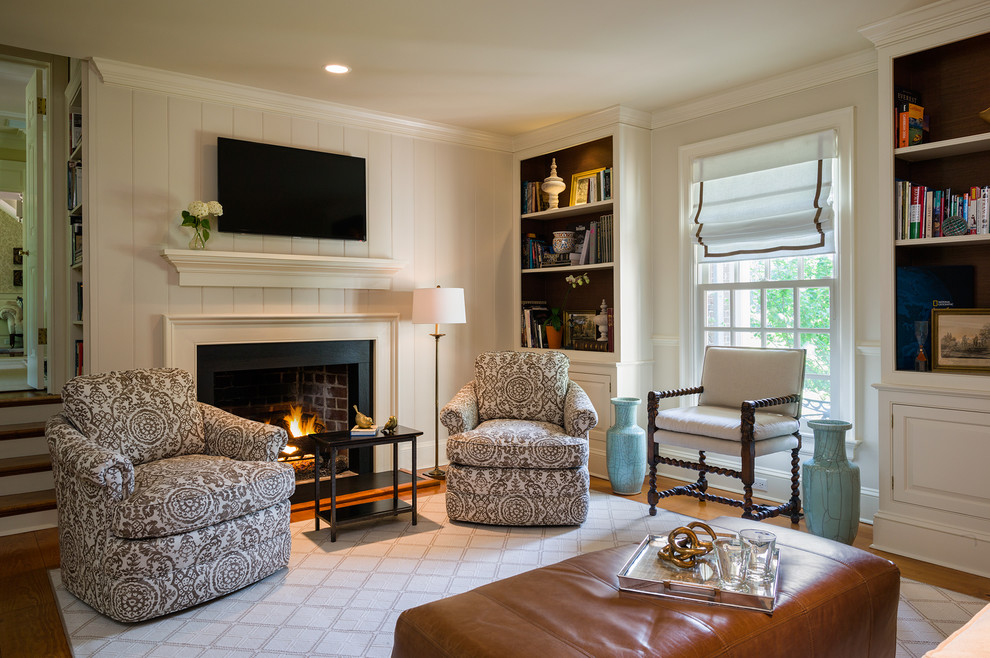 Foto di un soggiorno chic con sala formale, pareti beige, pavimento in legno massello medio e TV a parete