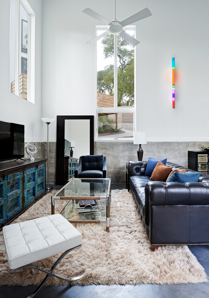 Mid-sized minimalist open concept concrete floor living room photo in Austin with white walls and a tv stand