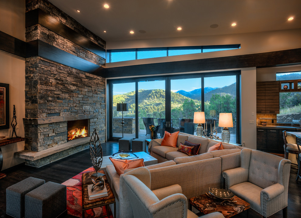 Design ideas for an expansive contemporary open plan living room in Salt Lake City with dark hardwood flooring, a standard fireplace, a stone fireplace surround and no tv.