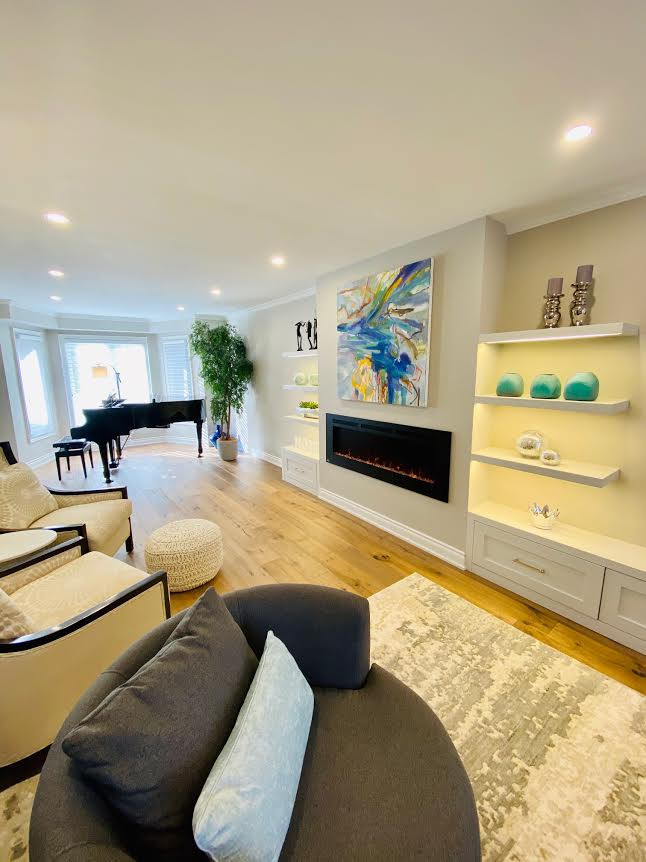 Photo of a large classic enclosed living room in Toronto with a music area, beige walls, light hardwood flooring, a ribbon fireplace, a metal fireplace surround, no tv and beige floors.