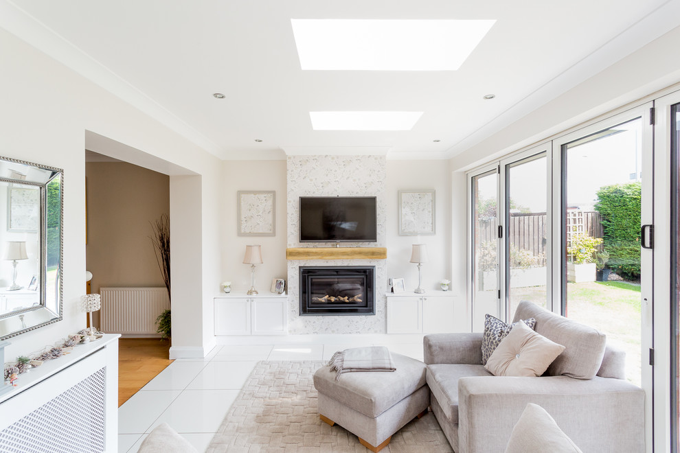 Design ideas for a medium sized contemporary open plan living room in Glasgow with a reading nook, white walls, porcelain flooring, a standard fireplace, a plastered fireplace surround, a wall mounted tv and white floors.