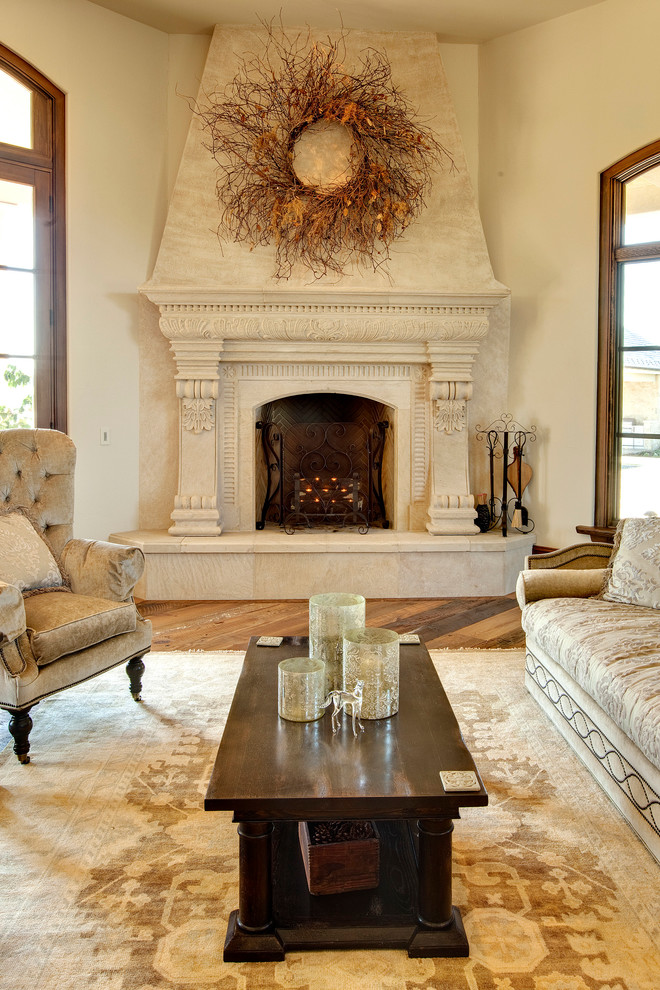 Living room - mediterranean living room idea in DC Metro with beige walls, a standard fireplace and a stone fireplace