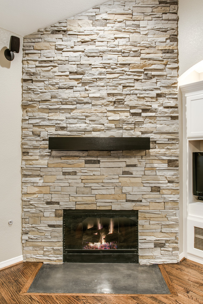 Example of a mid-sized transitional open concept dark wood floor living room design in Dallas with beige walls, a corner fireplace, a stone fireplace and a media wall