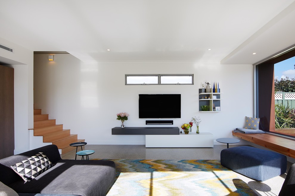 This is an example of a large contemporary open plan living room in Perth with grey walls, concrete flooring, no fireplace, grey floors and a wall mounted tv.