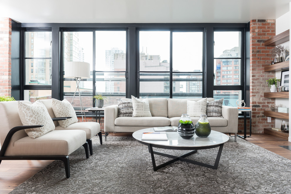 Inspiration for a mid-sized contemporary formal and open concept medium tone wood floor and brown floor living room remodel in Vancouver with white walls, no fireplace and no tv