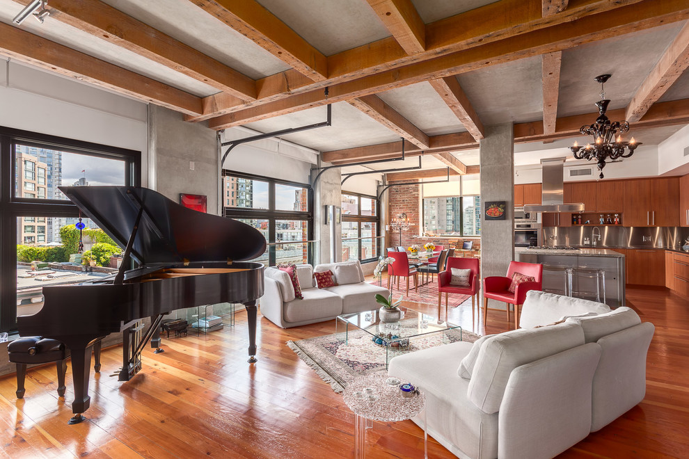 This is an example of an industrial formal open plan living room in Vancouver with multi-coloured walls, medium hardwood flooring, no tv and orange floors.