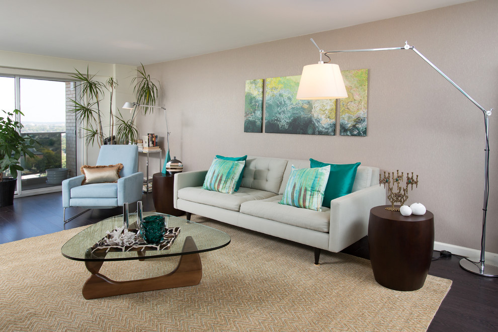 This is an example of a midcentury grey and teal living room in New York with grey walls.