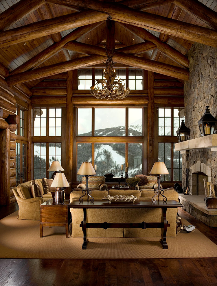 Large mountain style open concept dark wood floor living room photo in Denver with brown walls, a standard fireplace, a stone fireplace and a concealed tv
