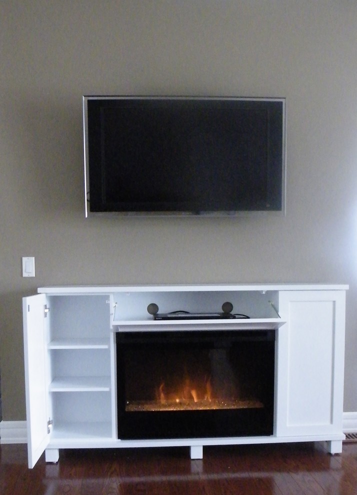 トロントにある低価格の中くらいなトランジショナルスタイルのおしゃれなLDK (白い壁、無垢フローリング、標準型暖炉、木材の暖炉まわり、壁掛け型テレビ) の写真