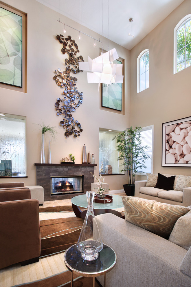 Living room - contemporary living room idea in Orange County with beige walls, a standard fireplace and no tv