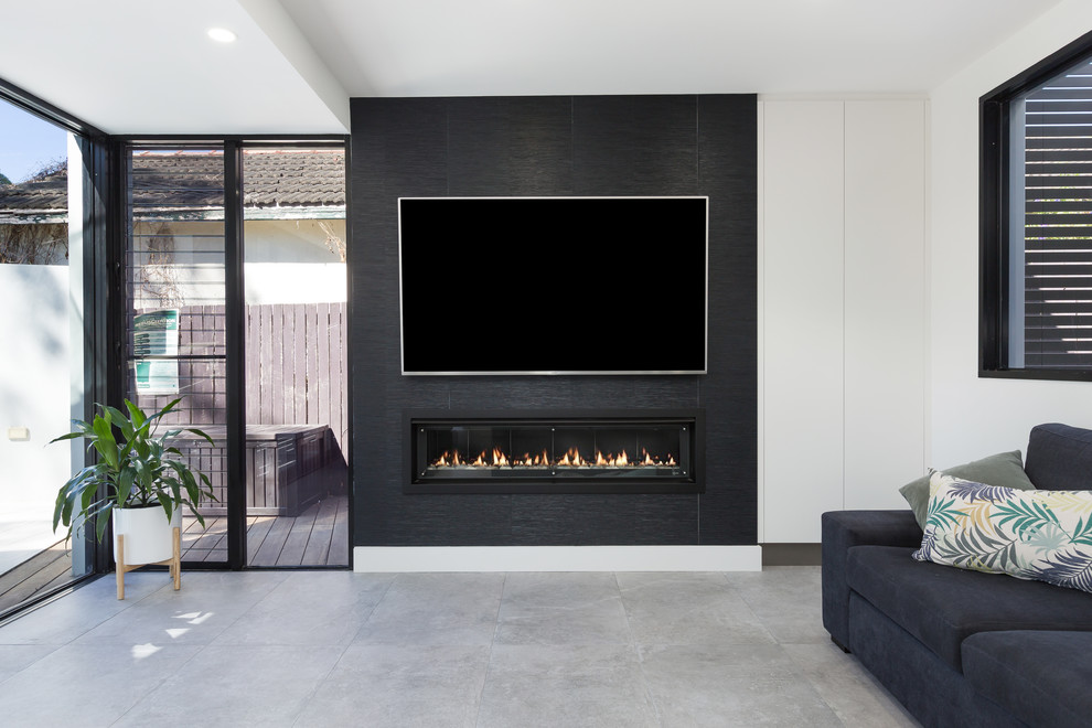 Photo of a large contemporary open plan living room in Sydney with white walls, porcelain flooring, a ribbon fireplace, a tiled fireplace surround, a wall mounted tv and grey floors.