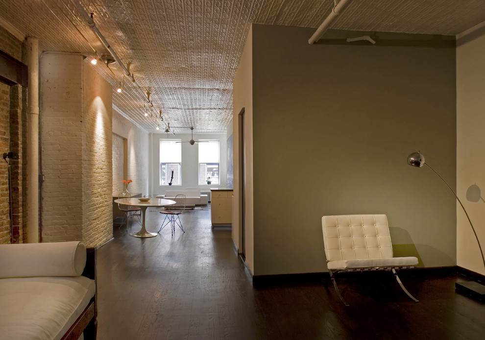 Example of an urban living room design in New York with beige walls