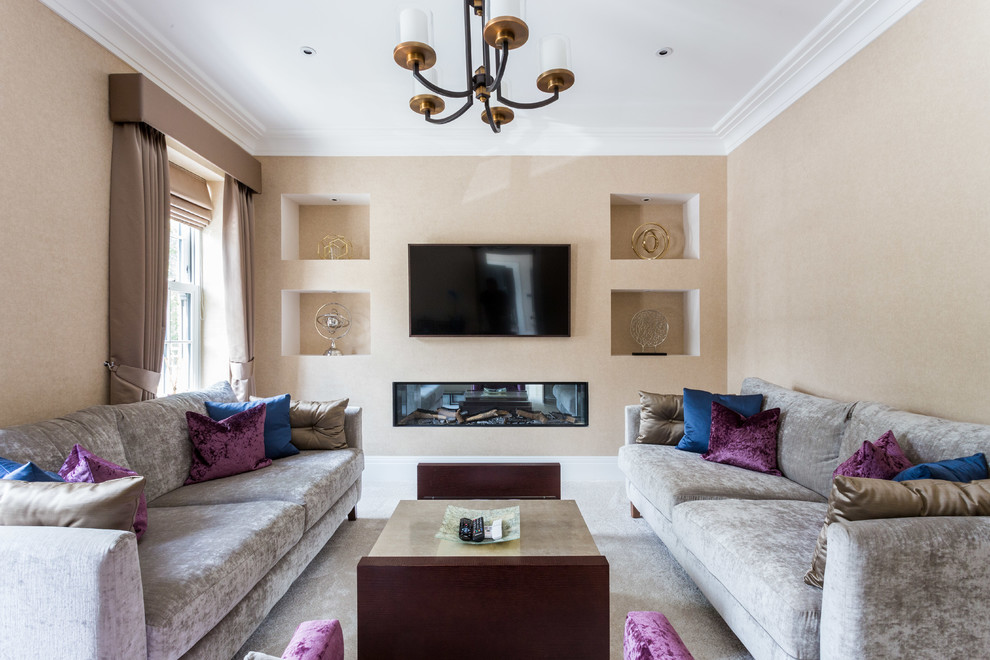 Inspiration for a medium sized traditional living room in Hertfordshire with beige walls, carpet, a wall mounted tv, grey floors and a ribbon fireplace.
