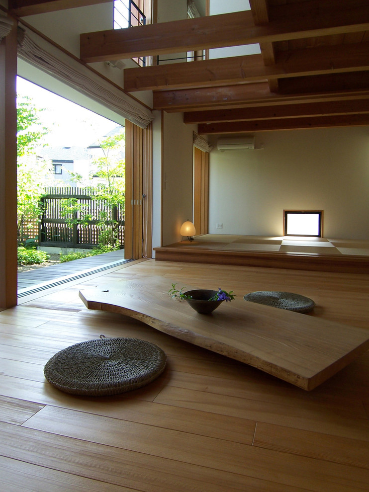 Ejemplo de salón de estilo zen sin chimenea con paredes beige y suelo marrón
