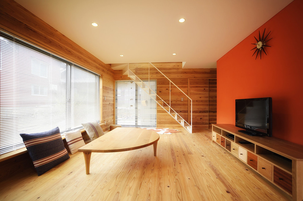 Contemporary living room in Other with medium hardwood flooring and a freestanding tv.