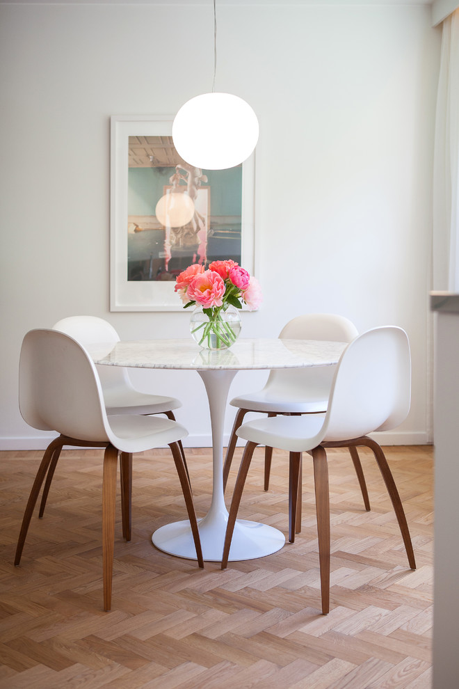 Inspiration for a mid-sized scandinavian light wood floor dining room remodel in Stockholm with white walls and no fireplace