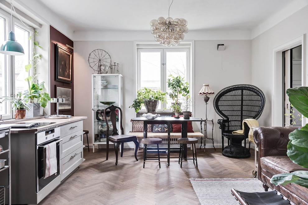 Photo of a medium sized eclectic open plan dining room in Malmo with grey walls, beige floors and light hardwood flooring.