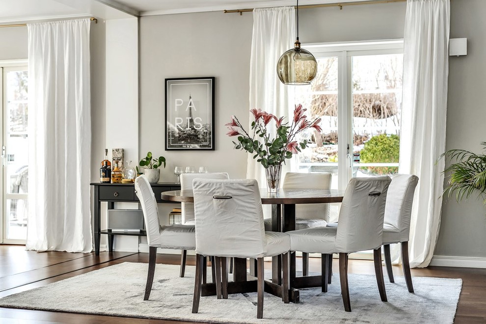 Photo of a medium sized traditional open plan dining room in Stockholm with grey walls and dark hardwood flooring.
