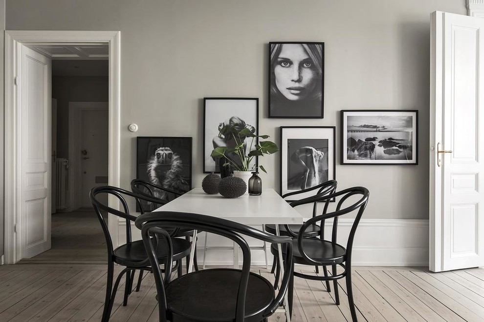 Photo of a medium sized scandinavian dining room in Stockholm with grey walls, light hardwood flooring and beige floors.