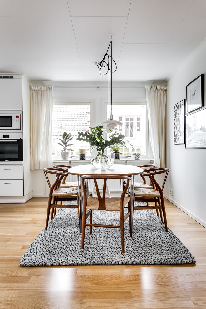 Inspiration for a large scandinavian dining room in Stockholm with white walls.