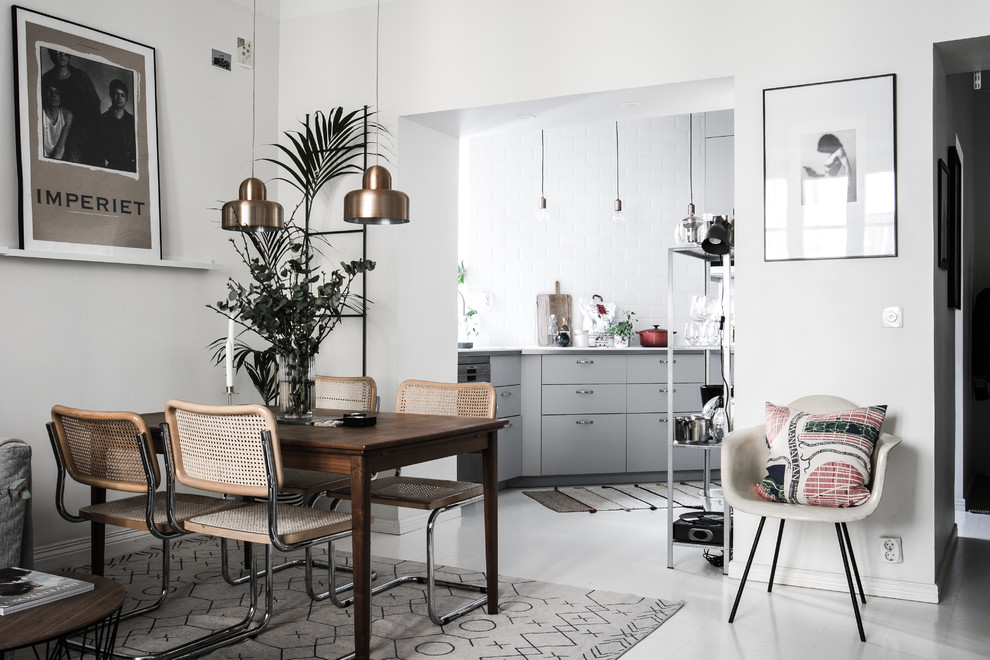 Photo of a medium sized scandi dining room in Stockholm with white walls, painted wood flooring and white floors.