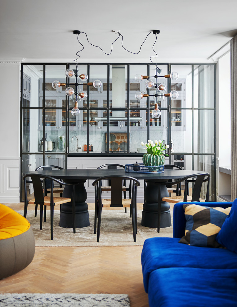 Immagine di una sala da pranzo aperta verso il soggiorno design con parquet chiaro, nessun camino, pavimento beige e pareti bianche