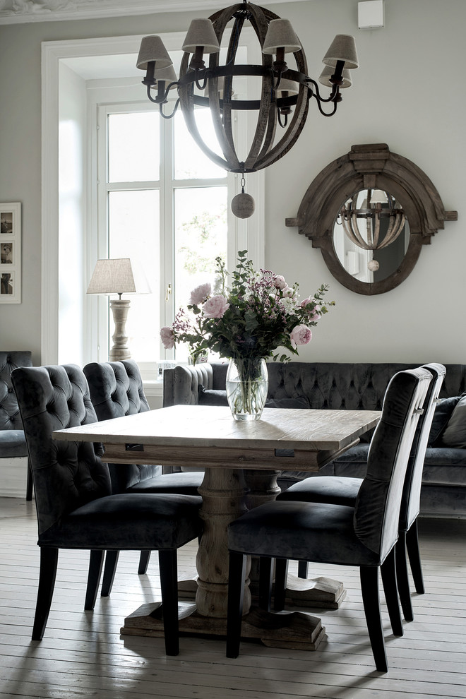 Large transitional medium tone wood floor and gray floor dining room photo in Gothenburg with white walls